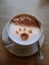 Original barista work - latte art with animal footprint and cinnamon on cappuccino.