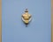 Original brass knocker in the shape of an antique vase on the bl