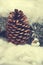 Original Christmas decoration with a large pine cone on a delic