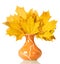 An original composition from yellow autumn leaves in vase isolated on white