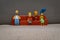 Original figures, toy characters of Simpsons family sitting on sofa together, 29 years old legendary symbol of cartoon TV shows