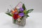 Original floral arrangement gift of fresh flowers in a box in the form of an envelope on a light background.
