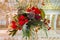 Original floral decoration in form of bunch of flowers on colorful background. Bouquets of flowers hanging from the
