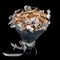 Original gift homemade in the form of a bouquet of different varieties of nuts and decorated with silver leaves isolated on black