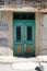 Original green wooden door with forged elements. Cyprus