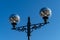 Original lanterns in the old style with modern lamps against the blue sky on Olympic Embankment in Sirius.