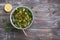 Original oriental salad tabbouleh with cabbage kale, parsley, bulgur, tomatoes and red onions on a wooden table