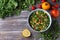 Original oriental salad tabbouleh with with ingredients cabbage kale, parsley and tomatoes on a wooden table