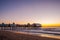 The original pier pier with old houses on the ocean at dawn.