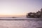 The original pier pier with old houses on the ocean at dawn.