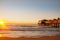 The original pier pier with old houses on the ocean at dawn.