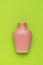 Original pink ceramic vase on a green background