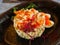 original serving of Russian salad with shrimps and red caviar.