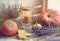 An original still life of Russia with the fire of a wax candle. Wax candle with pumpkin, apples and heather in the hay. Autumn sti