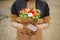 The original unusual edible vegetable and fruit bouquet with card in woman hands