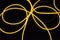 The original yellow lighting of thick electoluminescent wires and lines. Graphic abstract light background with interesting combin