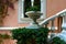 An ornament antique vase sits near the stone stairs with a historic architectural old building, Cote d`Azur, France. Summer times