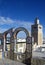 Ornamental arches on roof top terrace and mosque tower in Tunisia