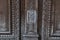 Ornamental carving wooden surface closeup of ancient door of Louvre museum in Paris France. Ornate wood texture of old double door