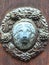 Ornamental door plaque with lion head in centre and vines around on historical door in Banska Stiavnica, Slovakia