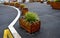 Ornamental flower pots next to the road to the square. ornamental perennial flowers grass. block shape flower pot made of wood mat