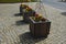 Ornamental flower pots on village center trough, wooden flower pots with beautiful decorations of violets and daffodils. Easter is