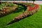 Ornamental flowerbed in front of the castle on the ground floor. The planting of annuals is in the shape of a circle with a moon s