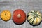 Ornamental pumpkins on a straw mat. wooden background.