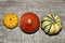 Ornamental pumpkins on a straw mat. wooden background.