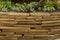 Ornamental stone masonry in the garden. Flat light brown stones.