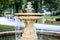 Ornamental water fountain in a park with runners