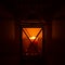 Ornamental wooden lantern with burning candle