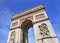 The ornate Arce de Triomphe against a blue sky, Paris, France