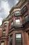 Ornate architectural details on urban brownstone apartments, city housing