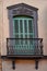 An ornate balcony and window shutters in Seville, Spain