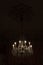 Ornate crystal chandelier in a dark room, centered