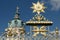 Ornate gilded decorations of the fence of Charlottenburg Palace, dome of the clock tower in the background, Berlin, Germany