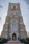 An ornate gothic stone curch entryway with bell tower