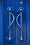 Ornate hardware of bright blue doors