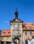 Ornate historic Baroque carved stone balcony on the exterior facade of the old medieval town hall on the bridges over the river