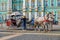 Ornate horse carriage awaiting tourist in front of the Winter Palace - Hermitage on Palace Square in Saint Petersburg, Russia