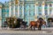 Ornate horse carriage awaiting tourist in front of the Winter Palace - Hermitage on Palace Square in Saint Petersburg, Russia