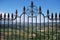 Ornate iron fence panel on the New Bridge with views across the Spanish countryside, Ronda, Spain.