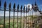 Ornate iron fence panel on the New Bridge with views across the Spanish countryside, Ronda, Spain.