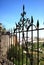 Ornate ironwork fence with views over part of the town and countryside, Ronda, Spain.