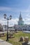 Ornate lamppost, ruins and Spasskaya tower of the Kazan Kremlin.