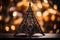 an ornate metal christmas tree sits on top of a table