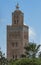 Ornate minaret against a blue sky in the city of Marrakesh