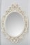 Ornate mirror on the wall. Round frame