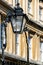 Ornate overthrow and lamp attached to the railings on The Circus, Bath